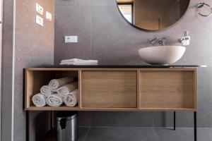a bathroom vanity with a sink and a mirror at Villa Piano Residences in Vantačići +72 photos