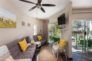 a living room with a couch and a flat screen tv at Casablanca 6 in Ballito