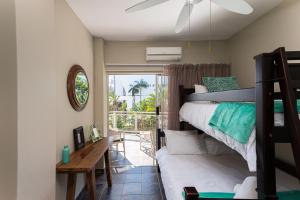 a bedroom with a bunk bed and a desk at Casablanca 6 in Ballito