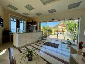 a kitchen with a view of the ocean at Horizon Beach Hotel in Plakias