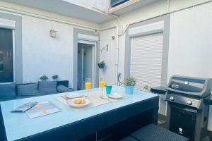 a table with two plates of food and drinks on it at La Perle Marine 3 in Le Grau-du-Roi