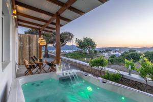 a hot tub on the patio of a house at Kallia's Suites Milos in Adamantas