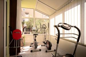 a gym with three exercise bikes and a window at Spacious Green Home in Hvar