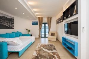 a bedroom with a large bed and a tv at Apartments Ponta Krasici in Tivat