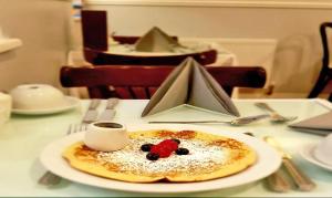 a plate of food on a table with a cup of coffee at Fitzwilliam Townhouse in Dublin