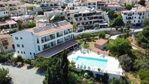 an aerial view of a building with a swimming pool at Pissouriana hotel Apartments in Pissouri