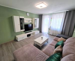 a living room with a couch and a tv at M & M Apartment in Pula