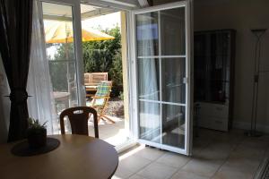 a room with a table and a sliding glass door at Fewo Sanddorn_BOBE in Ostseebad Karlshagen
