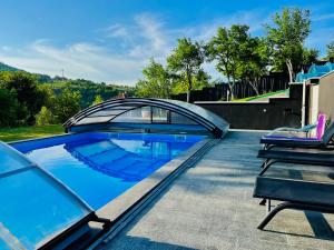 a swimming pool with a bridge on top of a house at Villa Diamond Hill in Sarajevo