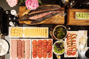 a table topped with lots of different types of food at Pałac Warlity in Olsztynek