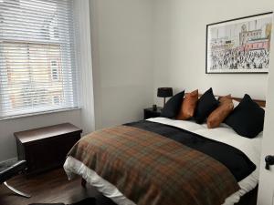 a bedroom with a bed and a window at The Lowry .. Where elegance meets Luxury! in Oban