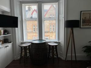 a room with two stools in front of a window at The Lowry .. Where elegance meets Luxury! in Oban