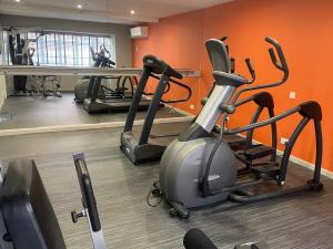 a gym with two exercise bikes and a treadmill at Kings Court Hotel in Alcester