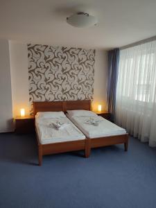 Postel nebo postele na pokoji v ubytování BEST Hotel Garni