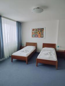 Posteľ alebo postele v izbe v ubytovaní BEST Hotel Garni