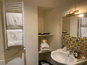 a bathroom with a sink and a mirror at Il Duomo Relais in Ragusa