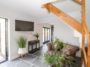 a living room with a staircase and a couch at Little Lugg in Hereford