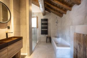 a bathroom with a bath tub and a sink at Chalets Choseaux Lézami in Saint-Sorlin-dʼArves +113 photos