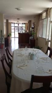 a table with wine glasses on it in a room at Hotel Islas Galapagos in Puerto Baquerizo Moreno