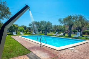 a pool with a water slide in a yard at Villa Grazia in Alghero