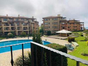 a view from a balcony of a building with a pool at Kaliakria Resort "Bluesky" in Topola