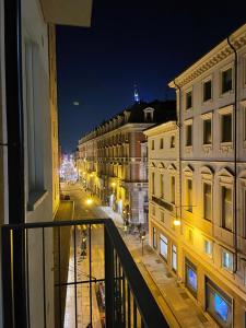 a view of a street at night from a balcony at IN CENTRO TORINO Charme Appartaments in Turin