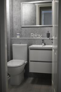 a bathroom with a toilet and a sink and a mirror at Ground Floor West End /City Centre / Rockvilla flat & Parking in Glasgow