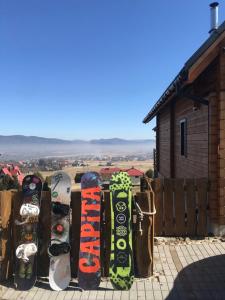 a group of snowboards lined up against a fence at Domek Panorama in Lipowa +6 photos