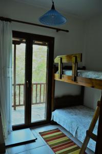 a bedroom with two bunk beds and a balcony at Villa skopelos in Skopelos Town