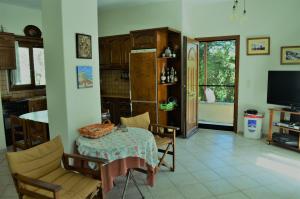 a kitchen with a table and chairs and a television at Villa skopelos in Skopelos Town