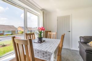 a dining room with a table and a couch at Suidhe in Bridlington