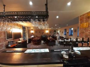 a bar in a restaurant with people sitting at tables at Slaley Retreat in Slaley