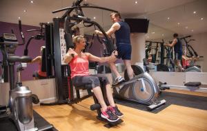 a man and a woman exercising in a gym at Slaley Retreat in Slaley