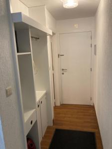 a hallway with a white door and a closet at My Fair - Koksijde in Koksijde
