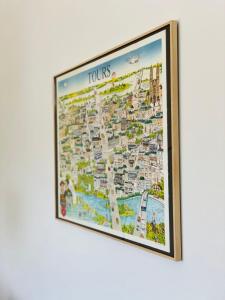 a framed map of tours hanging on a wall at La grange du Pigeonnier authenticity and gentleness 10 minutes from Tours in La Riche