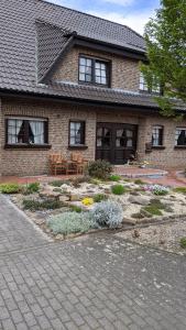 a brick house with a garden in front of it at Haus Münsterland in Nordwalde