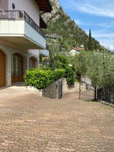 a house with a fence and a brick driveway at Villa Gianna in Limone sul Garda