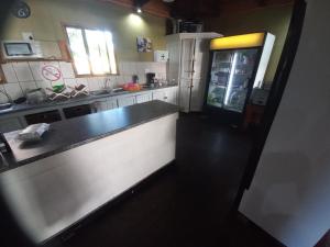 a kitchen with a counter and a refrigerator at Inhaca Kanimambo Lodge 