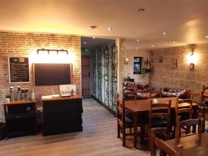 a restaurant with a bar and tables and chairs at Slaley Retreat in Slaley