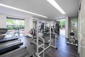a gym with treadmills and machines in a room at Mercure Sao Paulo Berrini in Sao Paulo
