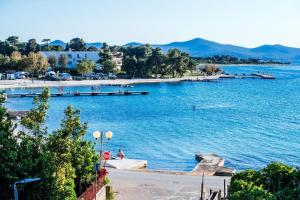 a large body of water with people swimming in it at Dedaj Resort - Villa Auri in Zadar
