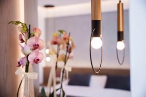 a group of vases with flowers and lights at Pavlo Napa Beach Hotel in Ayia Napa