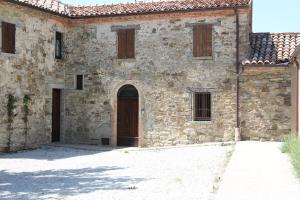 an old stone building with a wooden door at Podere Fabbrani in Pennabilli