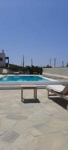 克洛瓦斯的住宿－Ftelia Breeze，游泳池前面设有长凳