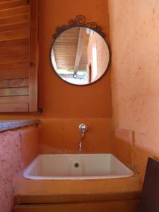 a bath tub in a bathroom with a mirror at Villetta Kala E Moru Sa oghe e su mare in Geremèas +36 photos