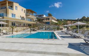 a swimming pool in front of a building at Spiros-Soula Thematic Suites in Agia Pelagia