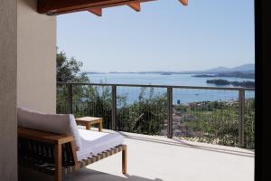 a room with a balcony with a view of the ocean at Greenstone Villas Corfu - Luxury Sea View Villas in Pyrgi