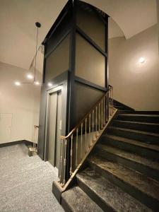 a staircase in a building with a black wall at IN CENTRO TORINO Charme Appartaments in Turin