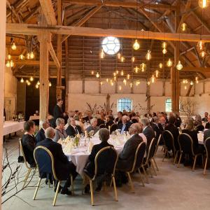 a group of people sitting at tables in a room at Skrøbelev Gods Manor House in Rudkøbing