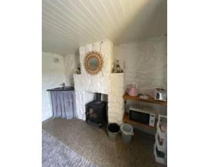 a room with a stone wall with a stove in it at Slieve Gullion Getaways in Meigh +21 photos